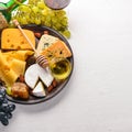 Food background with cheese. Blocks of moldy cheese, grapes, honey, nuts over on white background. Copy space. Royalty Free Stock Photo