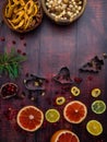 Food background with christmas spices, dried apples, nuts, citrus fruits, cydonia, cranberries, raisin, and baking dish on wooden Royalty Free Stock Photo