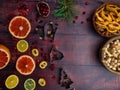 Food background with christmas spices, dried apples, nuts, citrus fruits, cydonia, cranberries, raisin, and baking dish on wooden Royalty Free Stock Photo