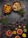 Food background with christmas spices, dried apples, nuts, citrus fruits, cydonia, cranberries, raisin, and baking dish on wooden Royalty Free Stock Photo