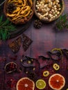 Food background with christmas spices, dried apples, nuts, citrus fruits, cydonia, cranberries, raisin, and baking dish on wooden Royalty Free Stock Photo