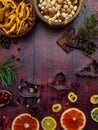 Food background with christmas spices, dried apples, nuts, citrus fruits, cydonia, cranberries, raisin, and baking dish on wooden Royalty Free Stock Photo