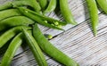 Food background. Close-up of a bunch of green pea pods on a wooden table. Royalty Free Stock Photo