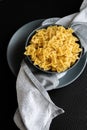 Food background - dry farfalle pasta on grey plate, whole wheat uncooked ingredient