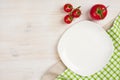 Food background with empty plate, tomatos and kitchen towel