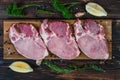 Food background of fresh raw meat of pork chop cutlet steak on wooden board with lemon, green pepper, thyme andv black pepper Royalty Free Stock Photo