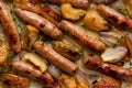 Food background. Oven baked turkey sausages with apples and shallot onions. Royalty Free Stock Photo