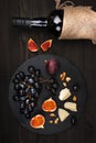 Food background with red wine, figs, grapes and cheese