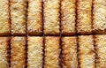 Cookies sticks sprinkled with sesame seeds are spread out on the table