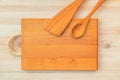 Food background. Top view of empty wooden cutting board, spoon and spatula on planks vintage table with copy space Royalty Free Stock Photo