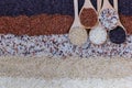 Food background with top view of five rows of rice in a wooden spoon