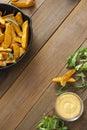 Food background. Top view of roasted potato in a frying skillet pan on wooden table. Copy space