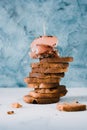 Food background. A tower of crispy toast with olives and ham and cream cheese canapes on a textural elegant white