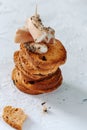 Food background. A tower of crispy toast with olives and ham and cream cheese canapes on a textural elegant white background.