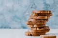 Food background. A tower of crispy toast with olives a on a textural elegant white and blue background. Crispy toast for