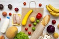 Food bag on white wooden table. Groceries background. Flat lay of fresh fruits, veggies, greens, meat, milk. Top view, overhead, f Royalty Free Stock Photo