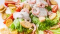 Food banner. Close-up appetizing salad with shrimp, lettuce, cheese, avocado and crackers on a white plate. Delicious and healthy Royalty Free Stock Photo