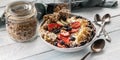 Food banner. Healthy breakfast in a bowl: Cottage cheese, granola, bananas, strawberries, blueberries and puffed rice. Wooden