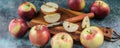 Food banner. Ripe apples and a knife on a wooden cutting board. Blue concrete background
