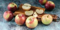 Food banner. Ripe apples on a wooden cutting board. Blue concrete background