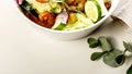 Food banner summer salad with fresh vegetables, fried shrimps, cheese and herbs. Seasonal vegetables, seafood and goat cheese. Royalty Free Stock Photo