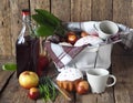 Food basket with a bottle of homemade wine and Easter cakes with eggs on a wooden rustic background.Preparing for a picnic