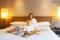 Food in bed serve in luxury hotel, woman on vacation enjoy breakfast Royalty Free Stock Photo