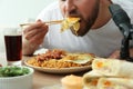 Food blogger eating in front of microphone at table. Mukbang vlog Royalty Free Stock Photo