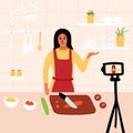 Food blogger. Female chef poses in the kitchen while recording video using camera online video channel. Cook healthy food at home