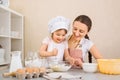 Food blogger mom and her daughter prepare dough, bake pies, enjoy the cooking process in the kitchen Royalty Free Stock Photo