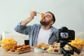 Food blogger recording eating show on camera. Mukbang vlog Royalty Free Stock Photo