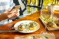 Food blogger taking photo of her lunch at cafe, closeup Royalty Free Stock Photo