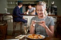 Food Blogger Taking Picture Of Restaurant Meal On Mobile Phone