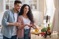 Food Bloggers. Young Arab Couple Recording Video While Cooking In Kitchen