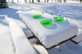 Food bowls on frozen picnic bench Royalty Free Stock Photo