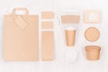 Food branding identity mockup in light modern style - blank coffee cup, packet, bag, box, label, card of brown paper on wood.