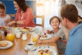 Food, breakfast and a playful family in the dining room of their home together for health or nutrition. Mother, father Royalty Free Stock Photo