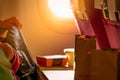 Food in brown paper bag put on plastic airplane tray table at seat back with blurred passenger hand opened black leather bag. Royalty Free Stock Photo