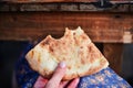 Food of the Caucasian Georgian kitchen,, a girl holds pieces in hands. Piece of pita bread in hand