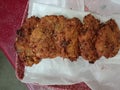 Food that is chapli kabab with different spices and vegetable and also with ketchup