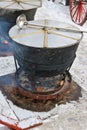 Food at the city`s spring fair is brewed on the street in huge s Royalty Free Stock Photo