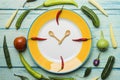 Food clock. Healthy food concept on wooden table Royalty Free Stock Photo