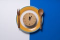 Food clock for lunch. Healthy food concept on white and blue background Royalty Free Stock Photo