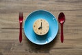 Food clock spoon and fork, Healthy food concept on wooden table background Royalty Free Stock Photo