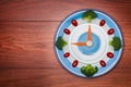 Food clock with vegetables, Healthy food concept, on wooden table Royalty Free Stock Photo