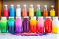 food coloring bottles lined up near icing cakes Royalty Free Stock Photo