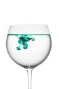 Food coloring diffuse in water inside wine glass area for slogan or advertising text message, on white background Royalty Free Stock Photo