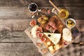 Food composition with cheese plate with cheese, dry meats, various fruits and nuts. Overhead of set of pieces moldy Royalty Free Stock Photo