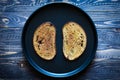 Food composition made of 2 slices of toasted bread in a black pan Royalty Free Stock Photo