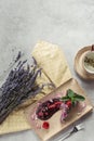 food composition with piece of blueberry cake served with mint leaves and violet petals on plate lavender and cup of herbal tea Royalty Free Stock Photo